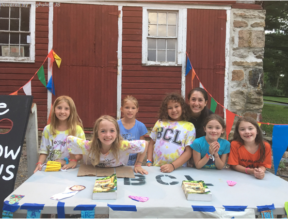 A group of young girls smiling for a picture